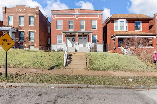 view of front of property featuring brick siding