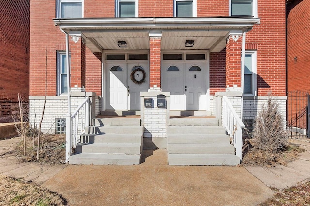 property entrance with brick siding