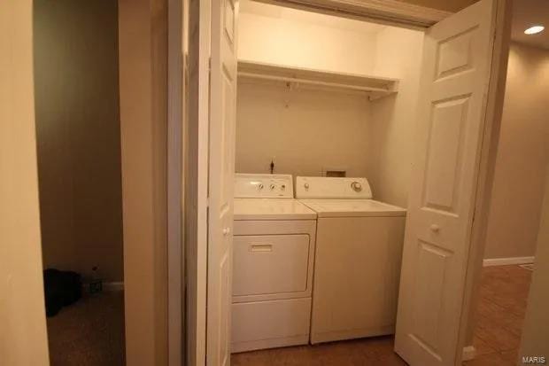 washroom featuring laundry area and washing machine and clothes dryer