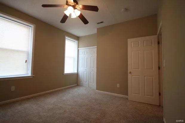 unfurnished bedroom with visible vents, baseboards, ceiling fan, carpet floors, and a closet