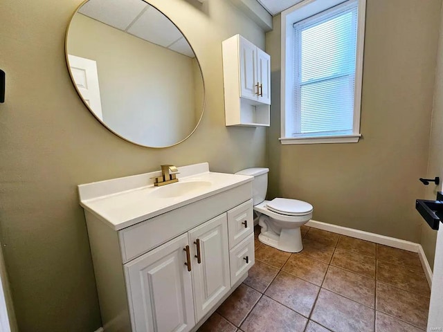 bathroom featuring tile patterned floors, vanity, toilet, and baseboards