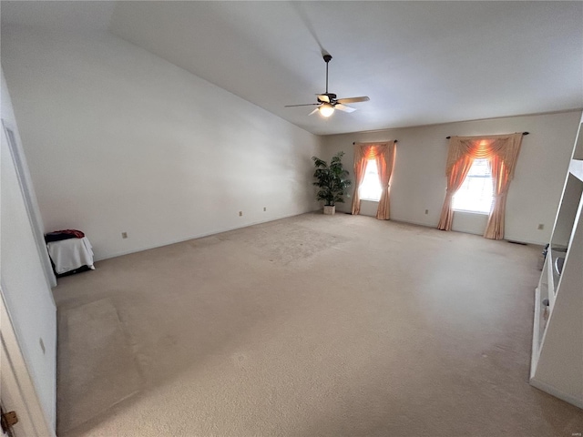 carpeted empty room featuring ceiling fan and vaulted ceiling