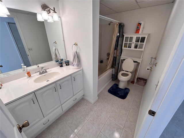 full bathroom with shower / tub combo with curtain, a paneled ceiling, tile patterned flooring, vanity, and toilet