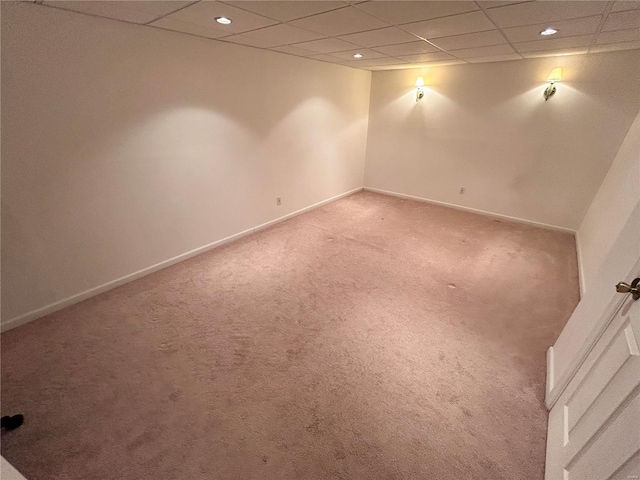 unfurnished room with a paneled ceiling and carpet floors