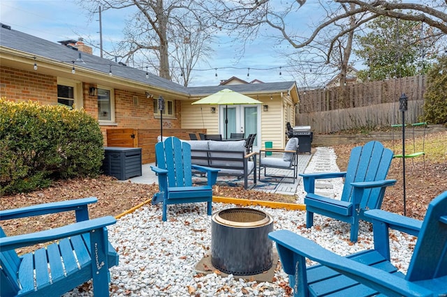 view of patio with area for grilling and an outdoor living space with a fire pit