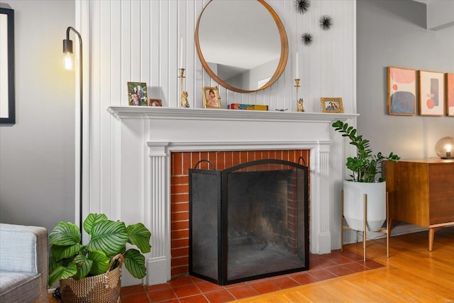 interior details featuring a fireplace and wood-type flooring