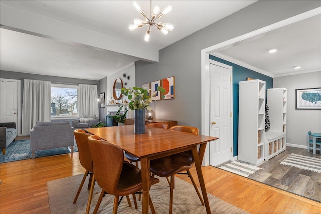 dining room featuring ornamental molding, an inviting chandelier, and wood-type flooring