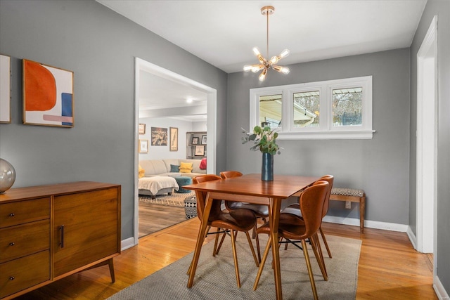 dining space featuring a chandelier and light hardwood / wood-style floors