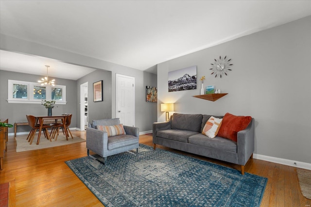 living room with hardwood / wood-style flooring and a chandelier