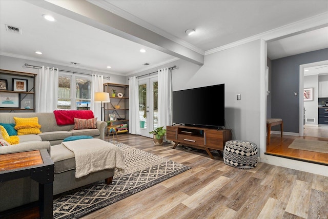 living room featuring french doors, hardwood / wood-style flooring, and crown molding