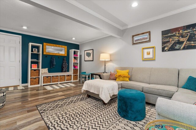 living room featuring hardwood / wood-style floors, beamed ceiling, built in features, and ornamental molding