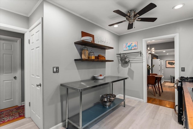 interior space featuring crown molding and light hardwood / wood-style flooring