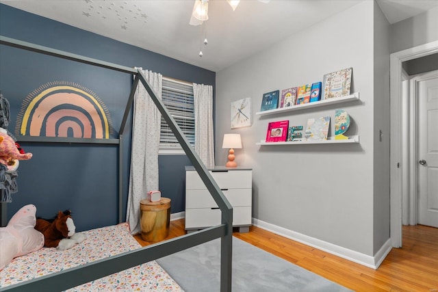 bedroom with hardwood / wood-style flooring