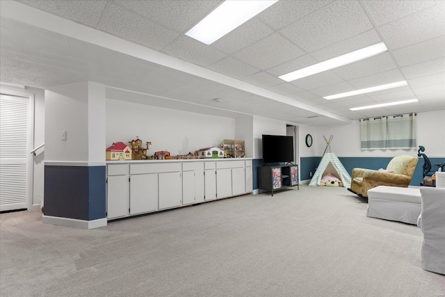 playroom with light carpet and a drop ceiling