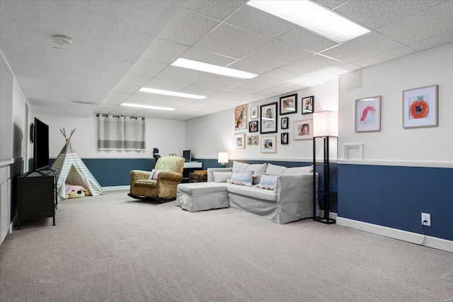 living room featuring a paneled ceiling and carpet floors