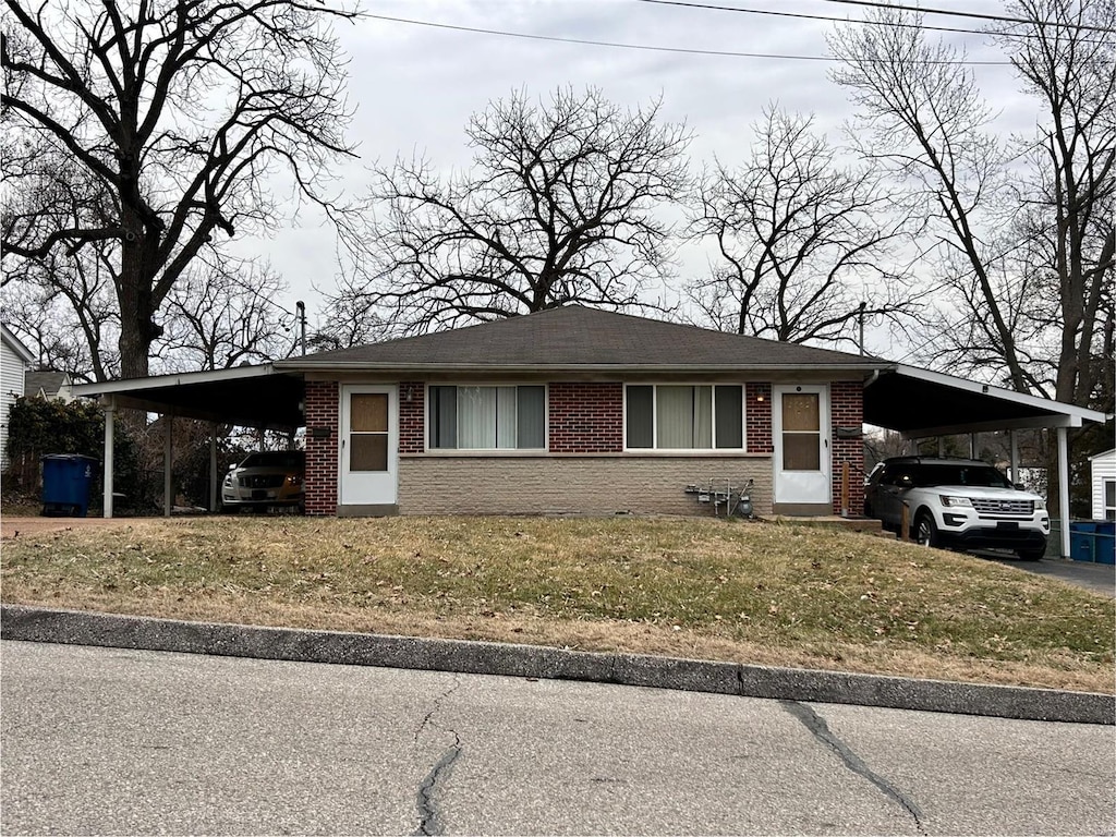 ranch-style home with a front lawn and a carport