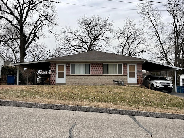 ranch-style home with a front lawn and a carport