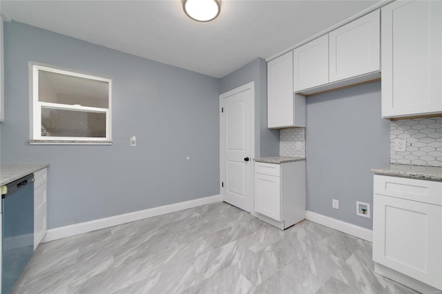 kitchen with white cabinetry, tasteful backsplash, and dishwasher