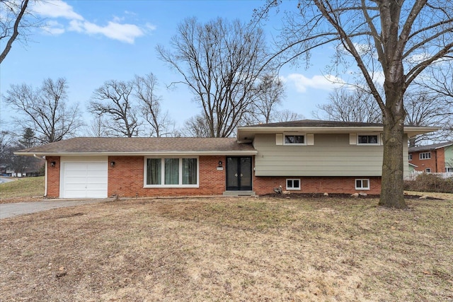 split level home featuring a garage and a front lawn