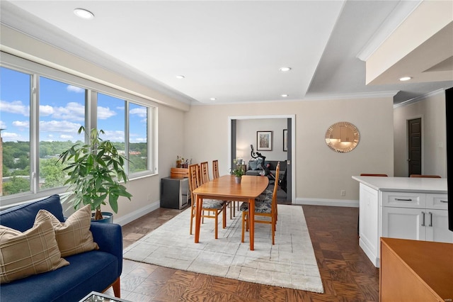 dining space featuring baseboards, crown molding, and recessed lighting