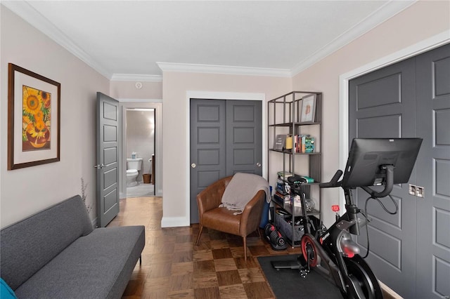 exercise area with baseboards and ornamental molding