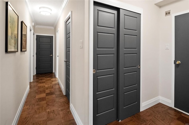 corridor with ornamental molding, visible vents, and baseboards