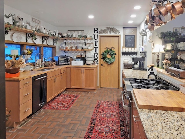 kitchen with wooden counters, stainless steel range with gas cooktop, sink, and black dishwasher