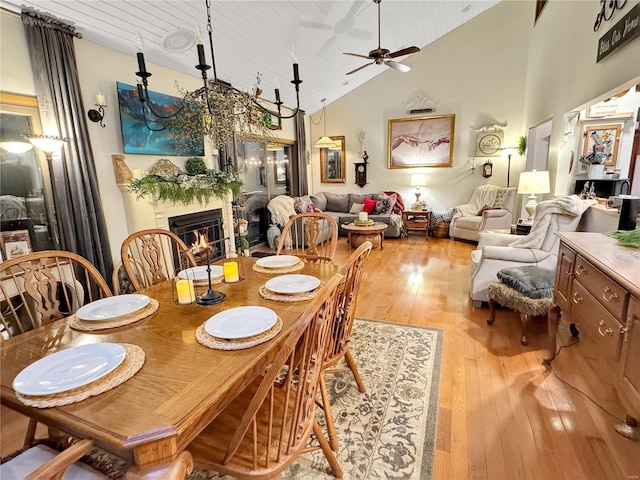 dining area featuring high vaulted ceiling, wood ceiling, light hardwood / wood-style floors, and ceiling fan