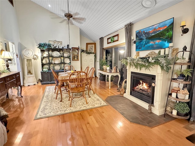 dining room with high vaulted ceiling, light hardwood / wood-style floors, wooden ceiling, and ceiling fan