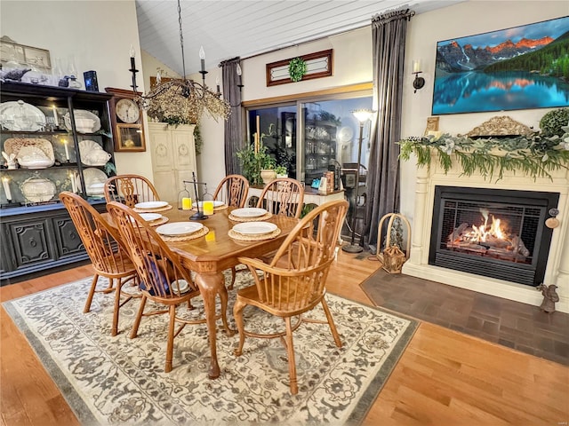 dining room featuring hardwood / wood-style flooring, wood ceiling, and lofted ceiling