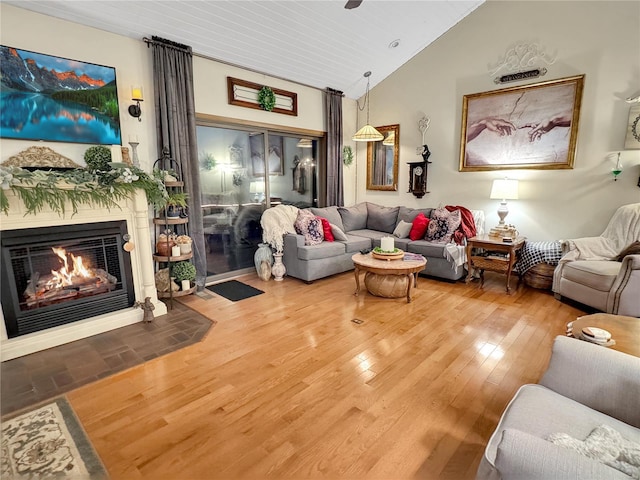 living room featuring vaulted ceiling and hardwood / wood-style floors