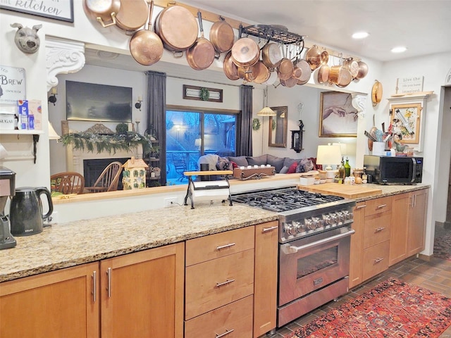 kitchen featuring light stone countertops and stainless steel stove