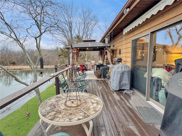 wooden terrace featuring a gazebo and a water view