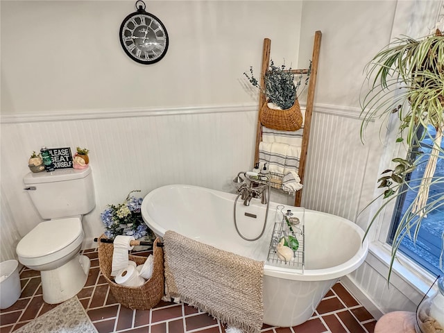 bathroom featuring toilet, a bathing tub, and tile patterned flooring