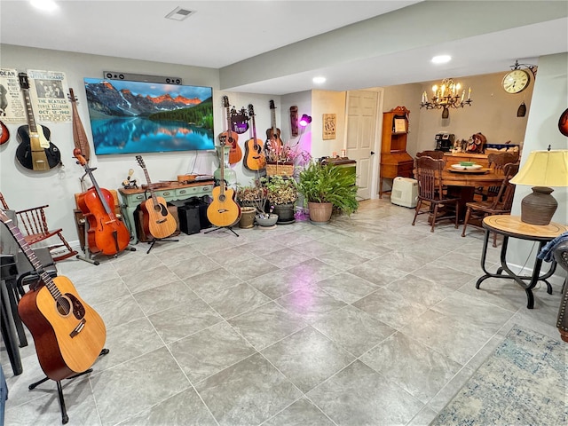 rec room with a chandelier