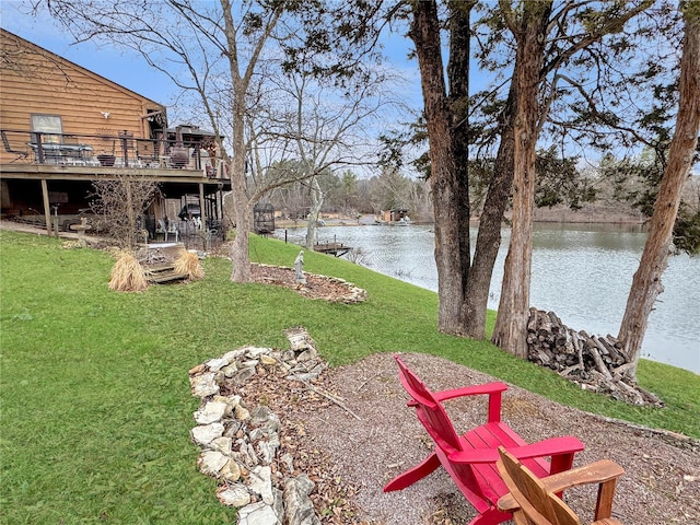 view of yard with a deck with water view