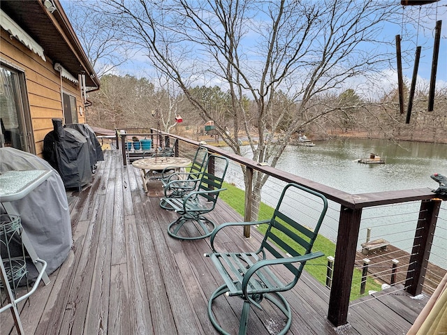 deck with a water view and grilling area