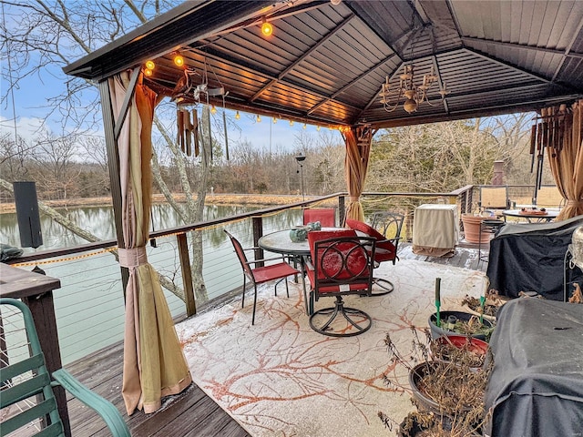 deck with a gazebo and a water view