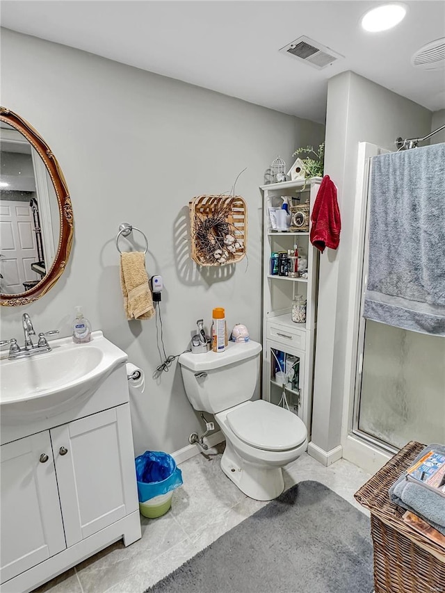 bathroom featuring tile patterned floors, vanity, toilet, and a shower