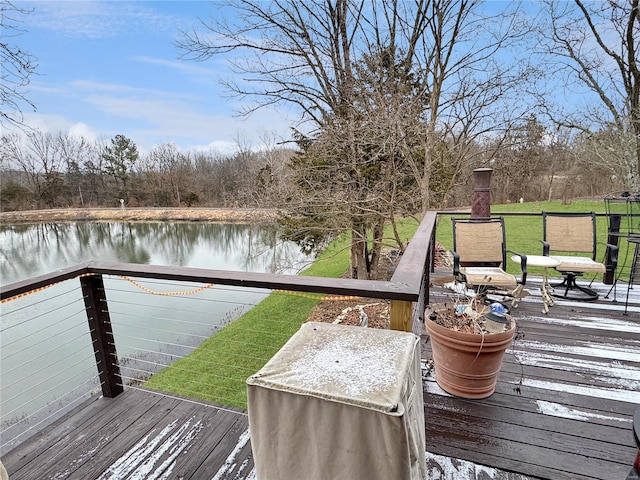 wooden terrace featuring a water view and a yard