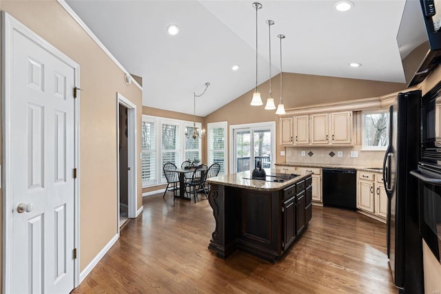 kitchen with vaulted ceiling, hanging light fixtures, black appliances, tasteful backsplash, and dark wood finished floors