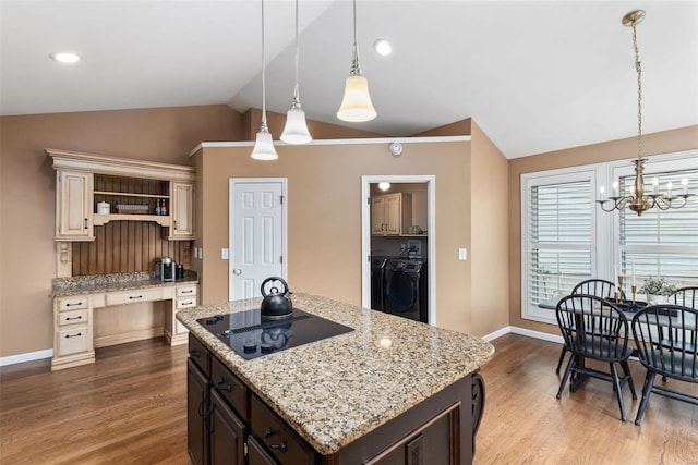 kitchen with lofted ceiling, black electric cooktop, independent washer and dryer, dark wood-style floors, and open shelves