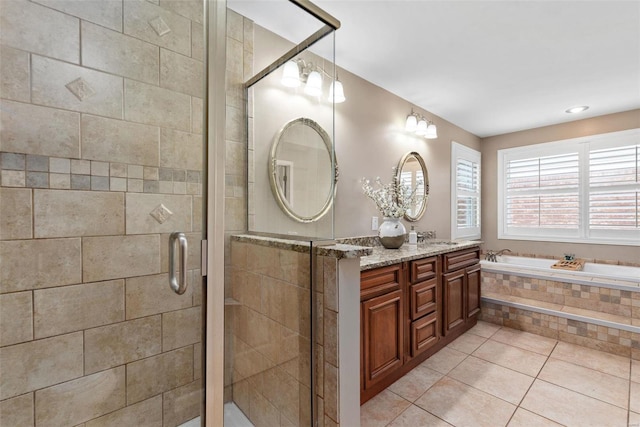 full bath with tile patterned flooring, a garden tub, a sink, a shower stall, and double vanity