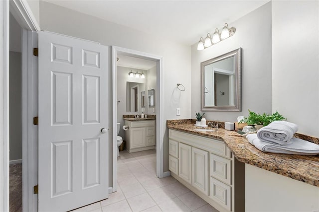 bathroom with vanity, toilet, and tile patterned floors