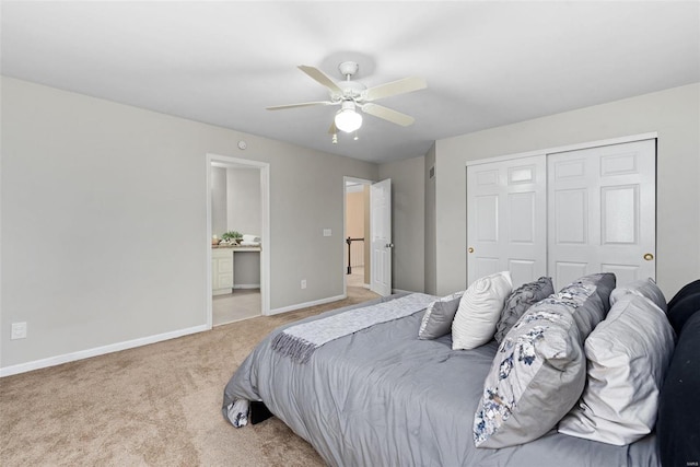 bedroom with a closet, light colored carpet, a ceiling fan, connected bathroom, and baseboards