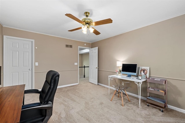 carpeted office space with ceiling fan, visible vents, baseboards, and ornamental molding