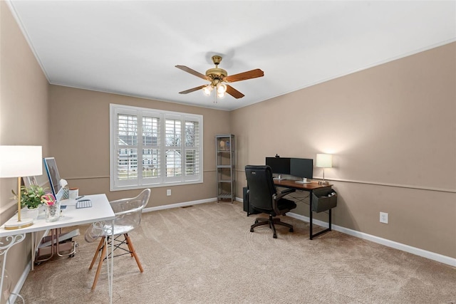 office space featuring a ceiling fan, carpet, crown molding, and baseboards