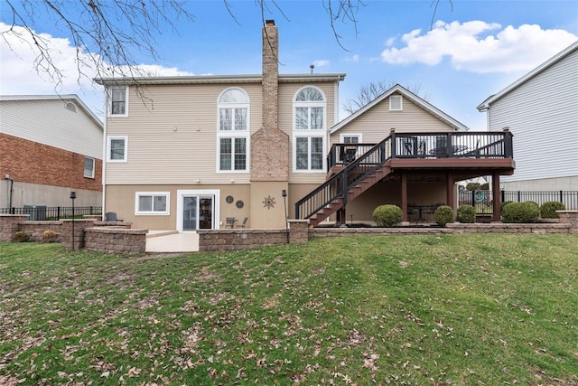 back of house featuring a yard, stairway, and a patio area