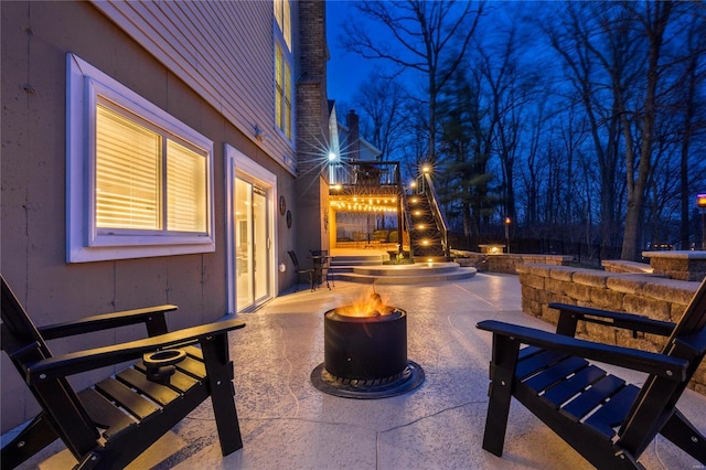 patio at night with an outdoor fire pit