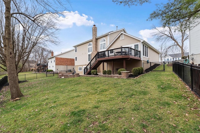 rear view of house with a fenced backyard, a yard, stairway, a wooden deck, and a chimney